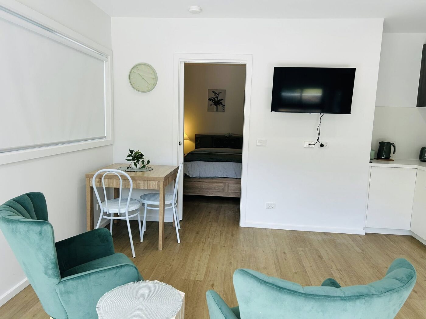 Open-plan studio cabin with lounge chairs and dining table